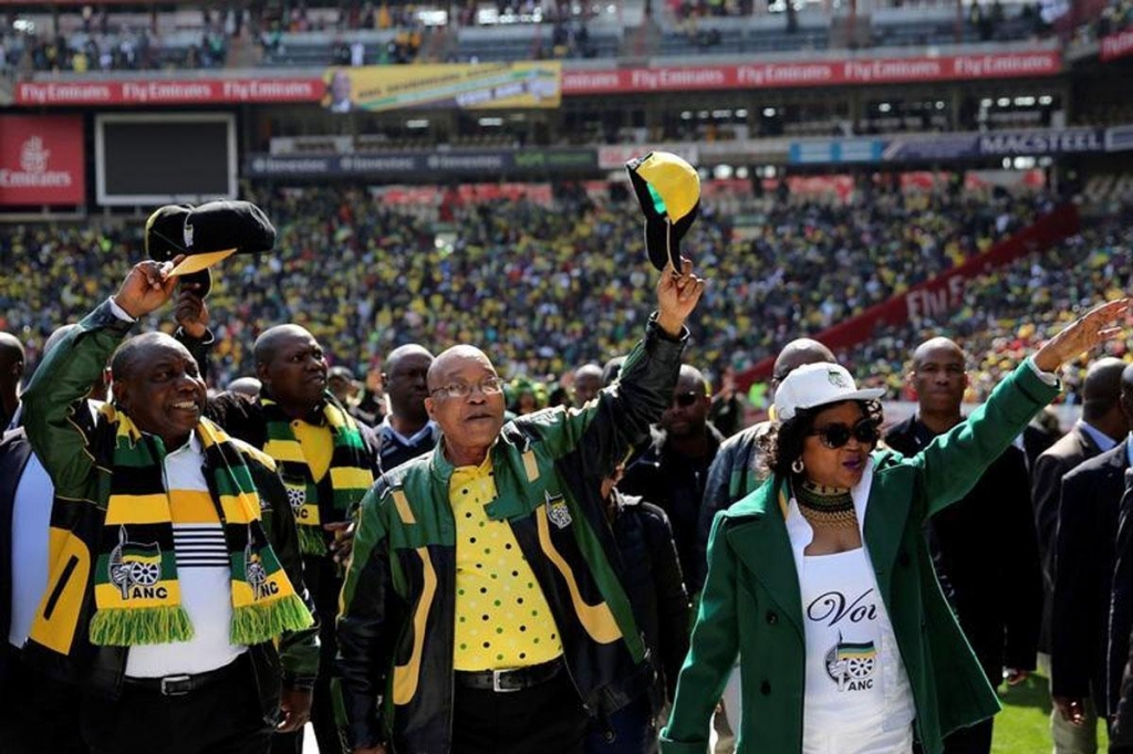 African National Congress president Jacob Zuma waves to his supporters next to his deputy Cyril Ramaphosa