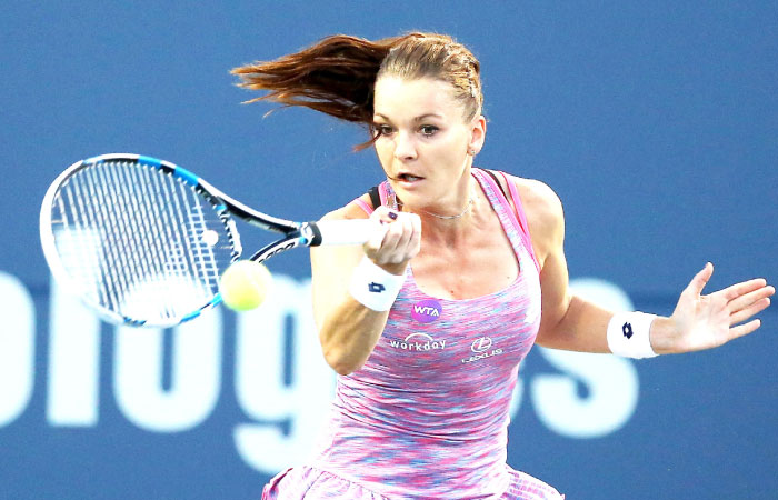 Agnieszka Radwanska of Poland returns a shot to Jelena Ostapenko of Latvia during their mach in New Haven Connecticut Tuesday. — AFP