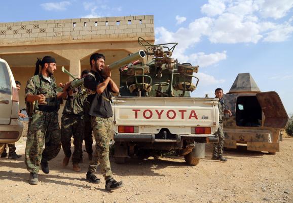 US-backed Syrian Opposition fighters prepare a rocket-launcher as they advance into the ISIS group bastion of Manbij in northern Syria