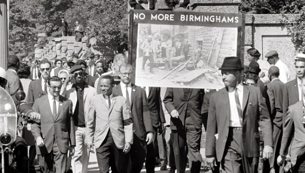 People march in memory of the 16th Street Baptist Church bombing victims. The banner shows