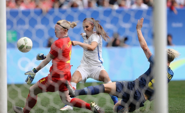 Alex Morgan of U.S. shoots against Hedvig Lindahl and Nilla Fischer of Sweden