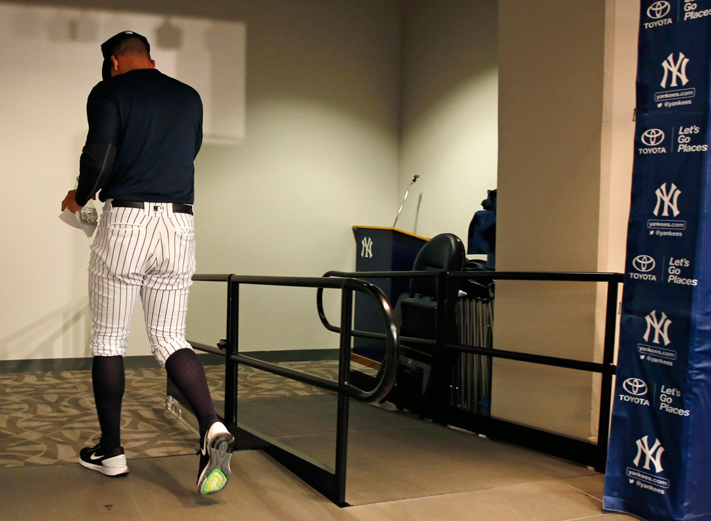 Alex Rodriguez leaves press conference wearing Nike sneakers after announcing retirement from New York Yankees.		AP Images