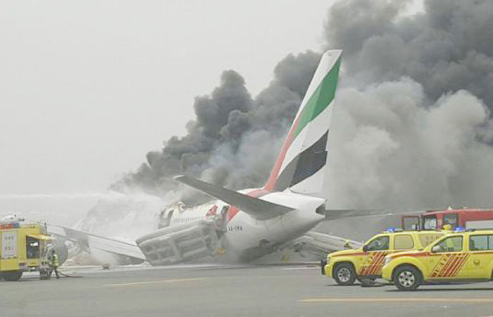 A thick black plume of smoke rising into the sky from Emirates Airline flight EK521 which caught fire after making an emergency landing at Dubai airport on Wednesday