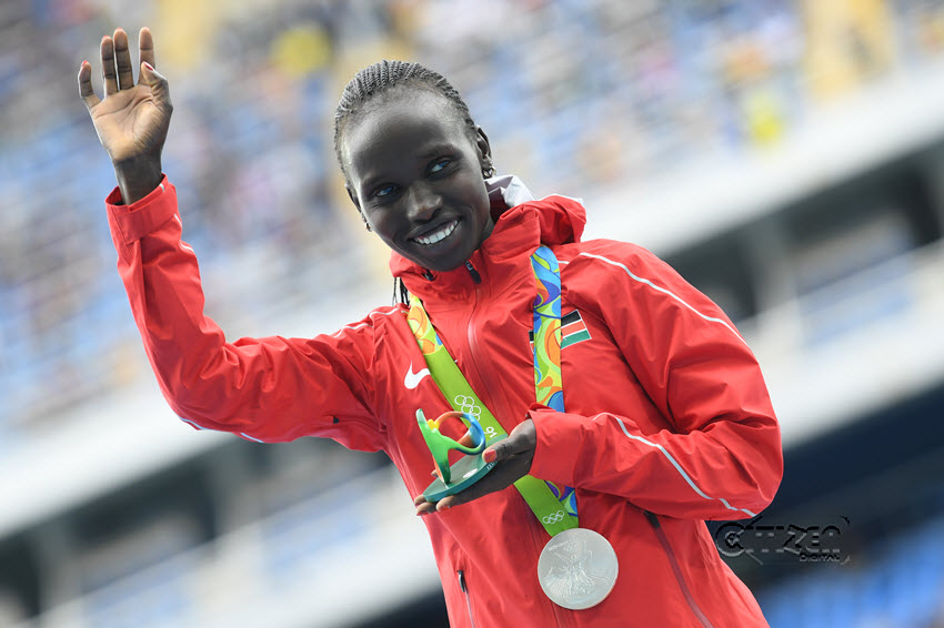 Silver medallist Kenya's Vivian Jepkemoi Cheruiyot waves on the podium during the medal ceremony for