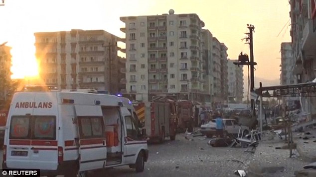 Ambulances rush to the scene of a roadside bomb blast in Kiziltepe Turkey after three people were killed and at least 25 were injured