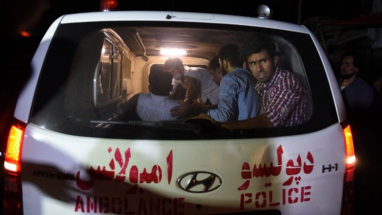 An injured man lies on a stretcher in an ambulance near the site of an explosion that targeted the elite American University of Afghanistan in Kabul