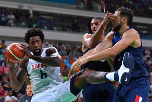 USA's centre De Andre Jordan loses his balance next to France's power forward Joffrey Lauvergne and France's small forward Nicolas Batum during a Men's round Group A basketball match between USA and France at the Carioca Arena 1 in Rio de Janeiro