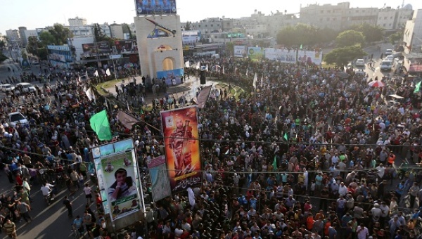 Palestinians gather during an anti Israel military parade staged by the armed wing of the Hamas movement in Rafah in the southern Gaza Strip Aug. 21 2016