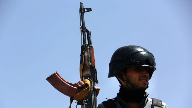 An Afghan Security policeman stands guard at the site of a truck bombing in Kabul earlier this month