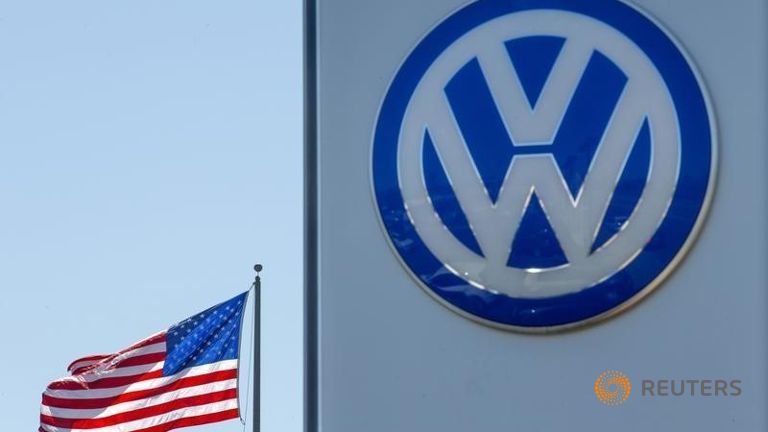 An American flag flies next to a Volkswagen car dealership in San Diego California