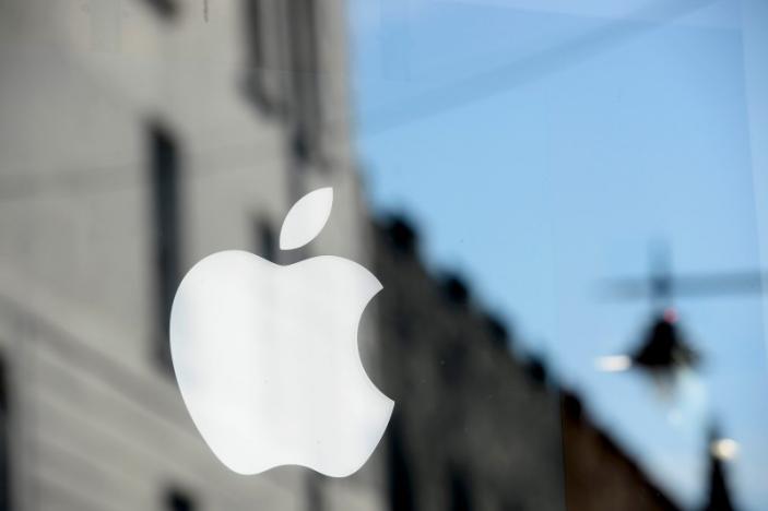 An Apple logo is seen in the window of an authorised apple reseller store in Galway Ireland