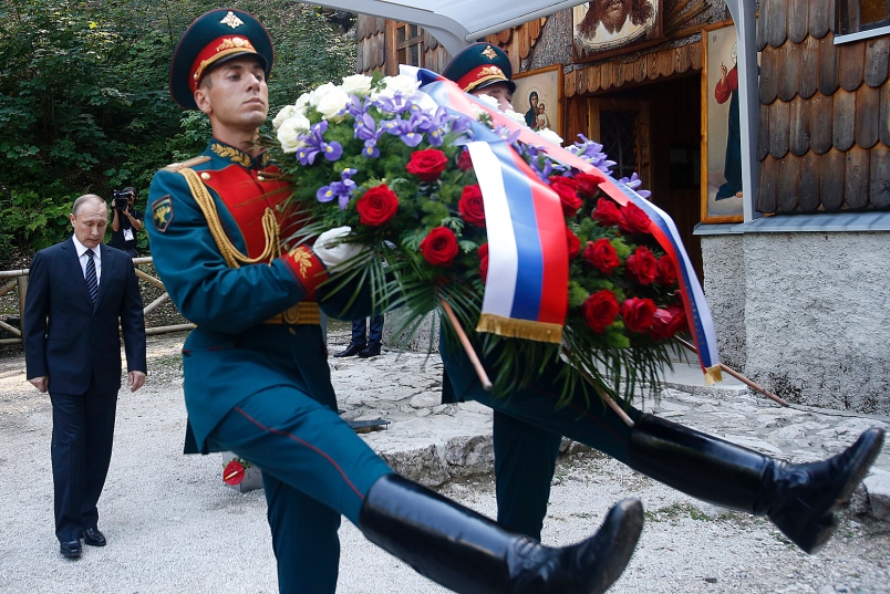 Russian President Vladimir Putin left attends a wreath-laying ceremony at a Russian Chapel in Kranjska Gora Slovenia on Saturday