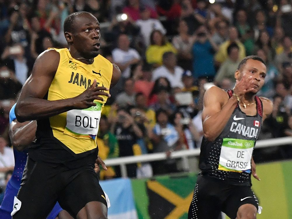 Puma partners Jamaica's Usain Bolt looks over towards Canada's Andre De Grasse as they near the finish line of the men’s 200-metre final at the Summer Olympic Games in Rio de Janeiro on Thursday. Bolt won his third straight gold medal