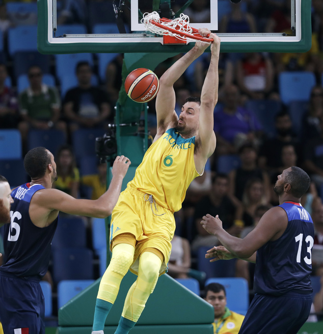 Australia's Australia's Andrew Bogut dunks the ball over France's Rudy Gobert left and Boris Diaw right during a basketball game at the 2016 Summer O