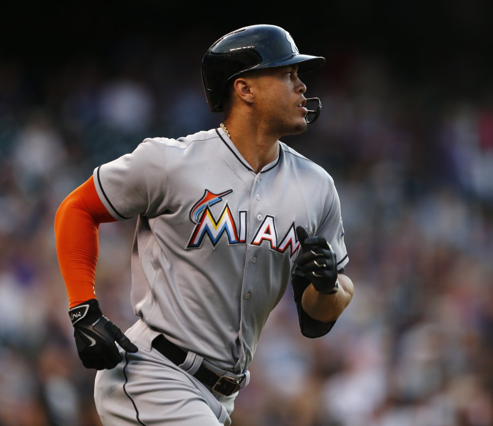 Miami's Giancarlo Stanton watches his homer soar an estimated 504 feet – the longest ever at Coors Field – during Saturday's game in Denver