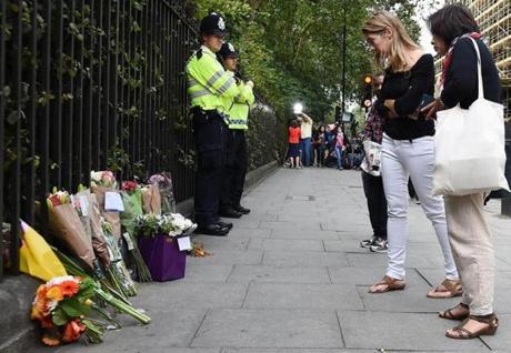 Flower were displayed Thursday at the scene of a stabbing attack in central London. An American woman was killed