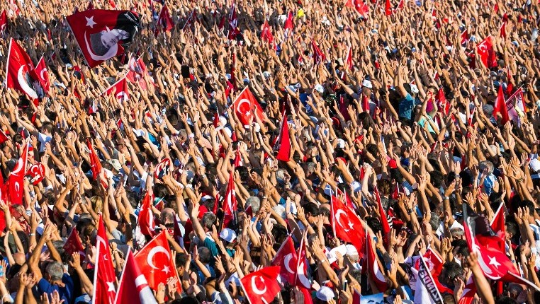 People wave Turkish flags and portraits of modern Turkey's founding father Mustafa Kemal Ataturk during a rally organised by the main opposition group the Republican People's Party