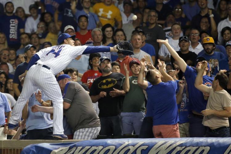 Anthony Rizzo gets up close and personal with the fans all while making the catch