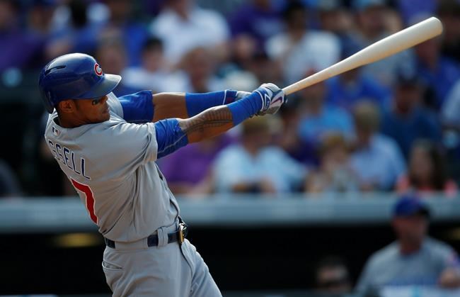 Chicago Cubs&#39 Addison Russell follows through with his swing after connecting for a solo home run off Colorado Rockies starting pitcher Jorge De La Rosa in the seventh inning of a baseball game Sunday Aug. 21 2016 in Denver. (AP