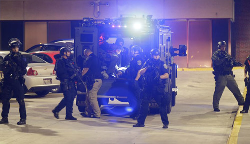 Armed police transport a man to a hospital after hes injured during unrest in Milwaukee Wisconsin on Aug. 14 2016. /AP