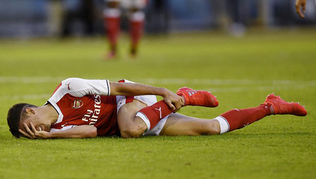 Arsenal defender Gabriel winces in pain after suffering an ankle injury against Manchester City