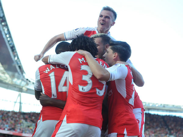 Arsenal players celebrate after scoring against Liverpool