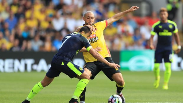 Arsenal's Alexis Sanchez and Watford's Nordin Amrabat compete for the ball