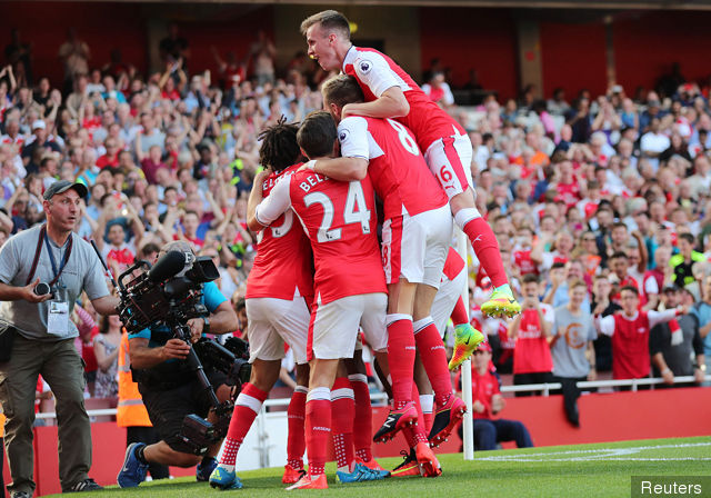 Arsenal's Theo Walcott celebrates scoring their first goal with Rob Holding and teammates