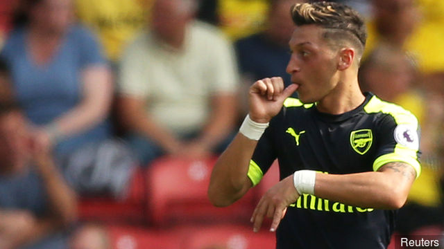 Arsenal's Mesut Ozil celebrates scoring their third goal