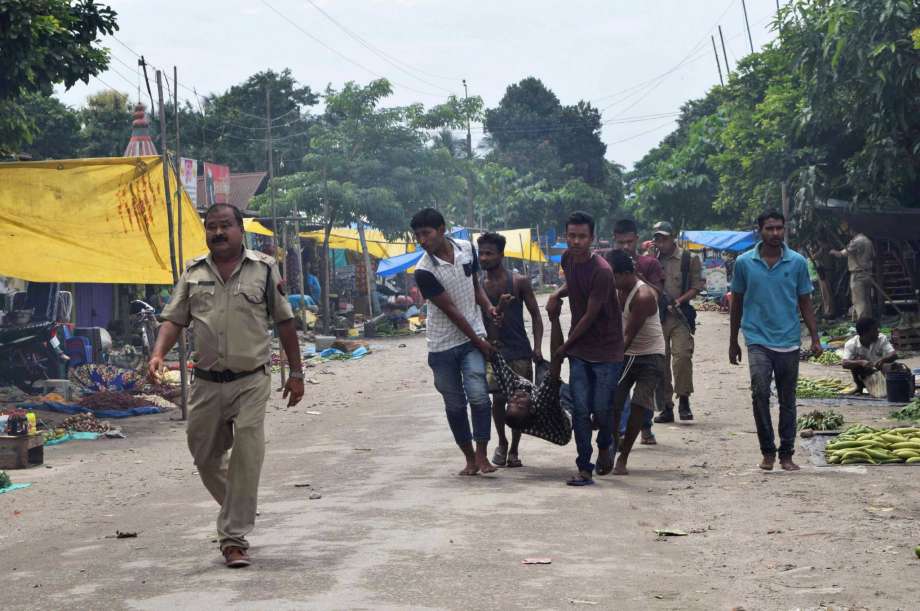 People carry a body after rebels opened fire in a crowded market at Kokrajhar in the north-eastern Indian state of Assam India Friday Aug. 5 2016. Dozens of rebel groups have been fighting the government and sometimes each other for years in seven