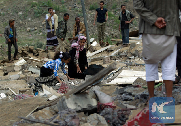 Yemenis inspect the rubble of a house in Yemen's rebel-held capital Sanaa