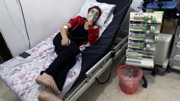 A civilian breathes through an oxygen mask at al Quds hospital after activists said a gas what they believed to be chlorine was dropped alongside barrel bombs on a neighbourhood in Aleppo Syria