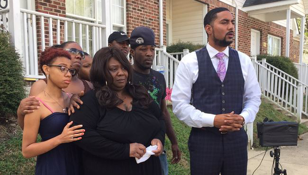 Attorney Justin Bamberg right stands with the family of Kouren Rodney Thomas in Raleigh N.C. Aug. 11 2016.               WNCN