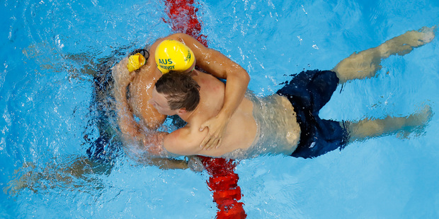 Australia's Kyle Chalmers gets a hug from Cameron Mc Evoy after winning the 100m freestyle finals