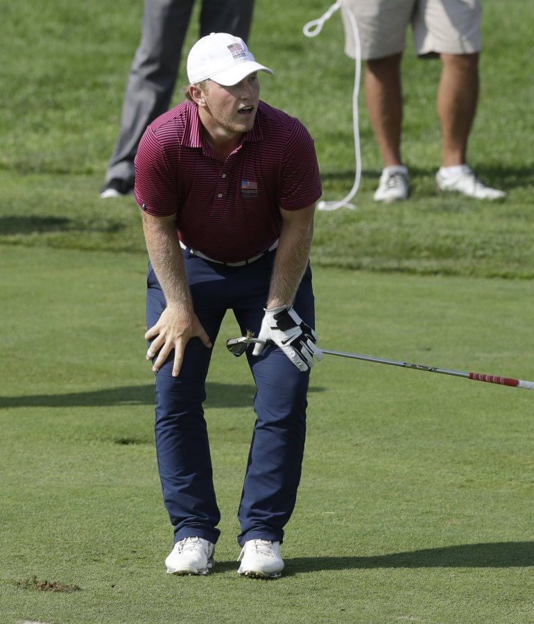 Associated Press Brad Dalke watches his approach shot on the 11th green during a semifinal round of the U.S. Amateur on Saturday at Oakland Hills Country Club in Bloomfield Township Mich