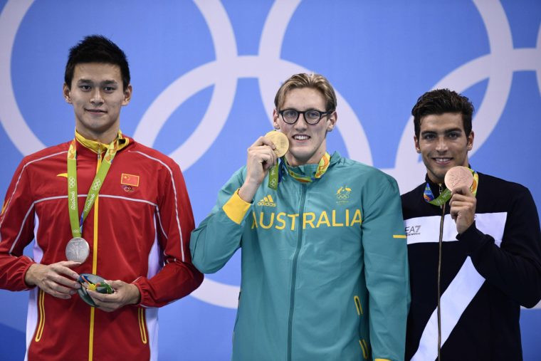 Australia's Mack Horton celebrates his gold on the podium with silver medallist Sun Yang on his left