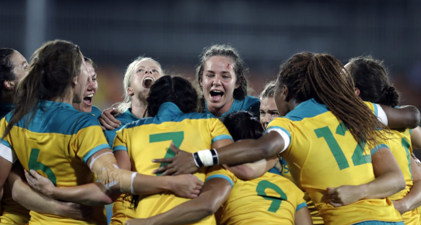 Australia's players celebrate after winning the women's rugby sevens gold medal match against New Zealand