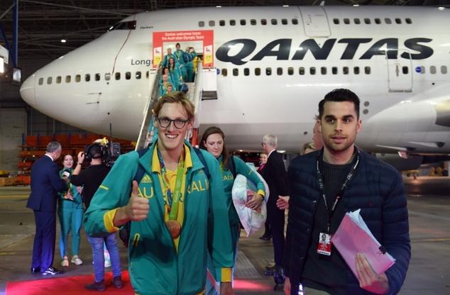 Australian Olympic gold medalist Mack Horton disembarks from the plane with other team members in Sydney