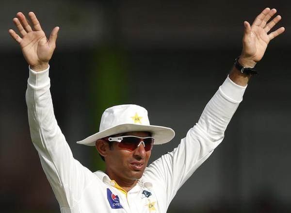 Pakistan's captain Misbah-ul Haq signals to the dressing room during the first day of their second and final test cricket match against Pakistan in Colombo