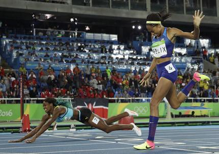 Bahamas&#039 Shaunae Miller falls over the finish line to win gold ahead of United States&#039 Allyson Felix right in the women's 400-meter final during the athletics competitions of the 2016 Summer Olympics at the Olympic stadium in Rio de Janei