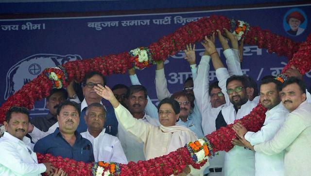 Bahujan Samaj Party chief Mayawati is garlanded at a mega rally in Azamgarh on Sunday