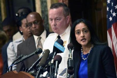 Principal Deputy Assistant Attorney General Vanita Gupta right speaks during a news conference as Police Commissioner Kevin Davis second from right and City Council president Bernard C. Jack Young listen at City Hall in response to a Justice Departmen