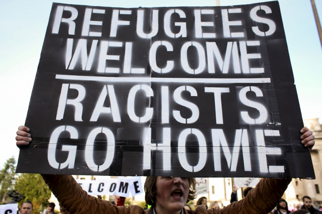 A pro-refugee counter-protester shouts during another group's protest against the United States acceptance of Syrian refugees at the Washington State capitol in Olympia Washingt