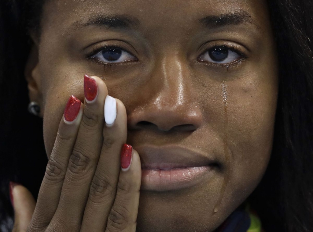 United States gold medal winner Simone Manuel cries during the medal ceremony for the women's 100-meter freestyle final during the swimming competitions at the 2016 Summer Olympics