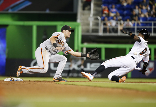 San Francisco Giants second baseman Joe Panik right waits for the throw as Miami Marlins Dee Gordon steals second base during the sixth inning of a