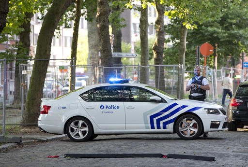 Police officers secure the scene near the police headquarters in Charleroi Belgium Saturday Aug. 6 2016. ﻿ Two female officers were attacked and wounded by a man wielding a machete and shouting