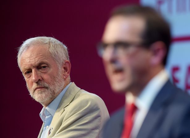 Jeremy Corbyn watches Owen Smith speak during the first Labour leadership debate