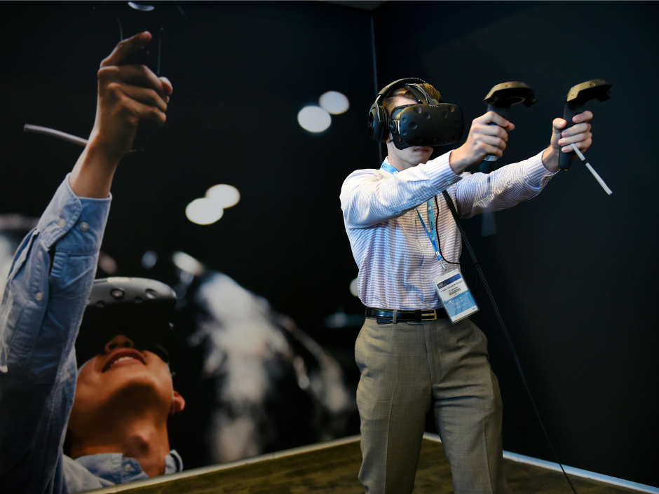 An attendee plays a game on an Oculus Rift virtual reality headset during the 2016 Intel Developers Forum