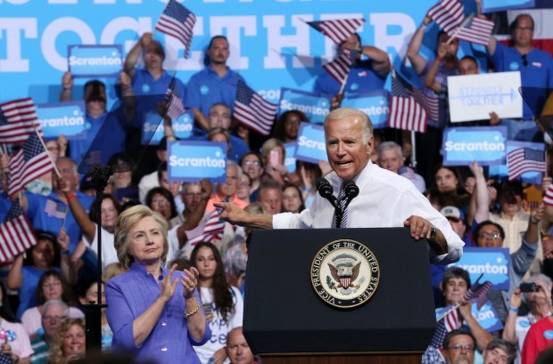 Democratic presidential candidate Hillary Clinton listens at left as Vice President Joe Biden speaks at a campaign rally Monday Aug. 15 2016 in Scranton Pa