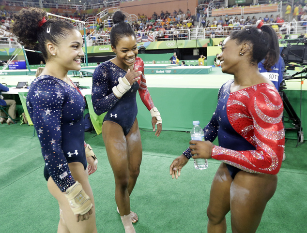 From left United States Lauren Hernandez Gabrielle Douglas and Simone Biles stand together after their floor routine during the artistic gymnastics women